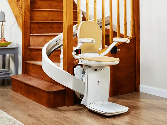 Curved stairlift with custom rail on a turning staircase in Parkland, WA
